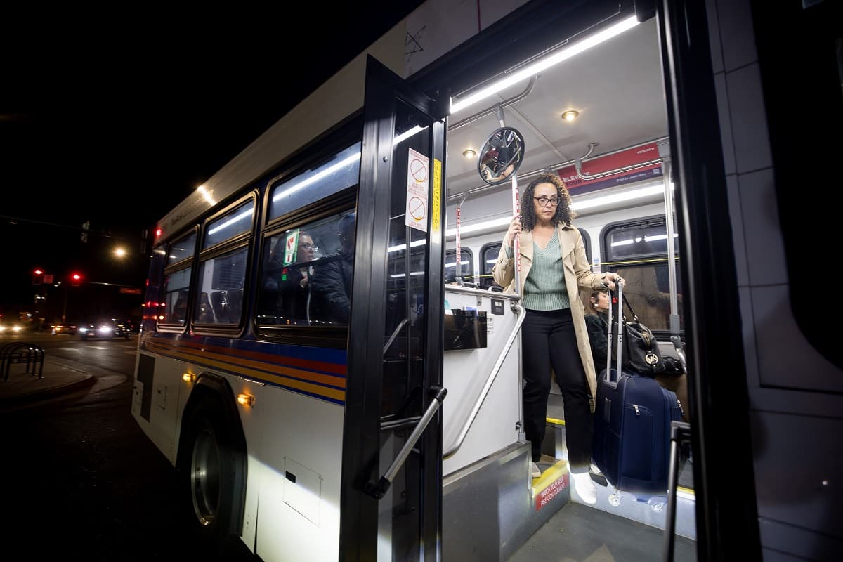 Woman getting off a bus