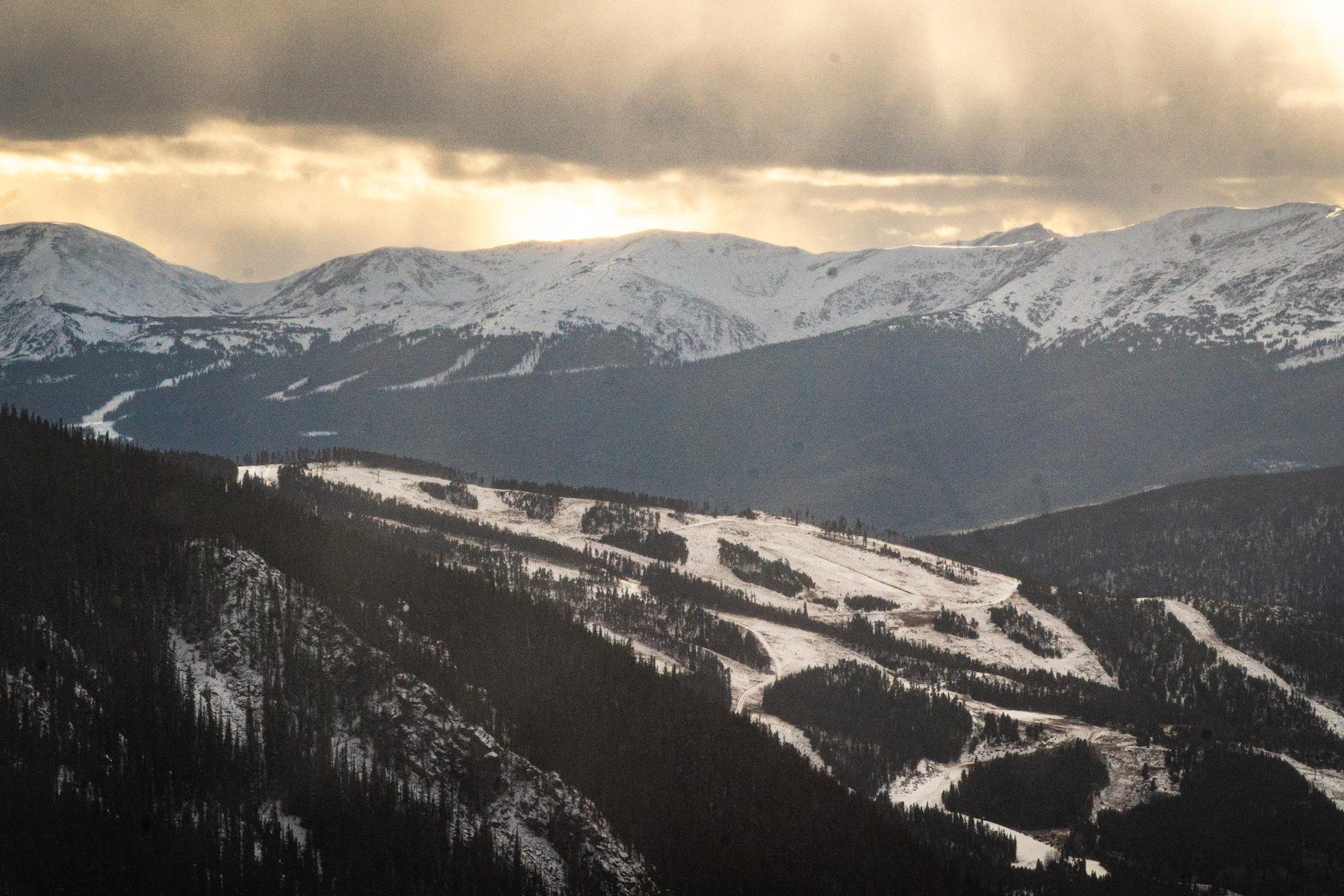 With Keystone in the foreground, cloudy weather blows in over the Ten Mile Range in Summit County as the sun sets behind the peaks