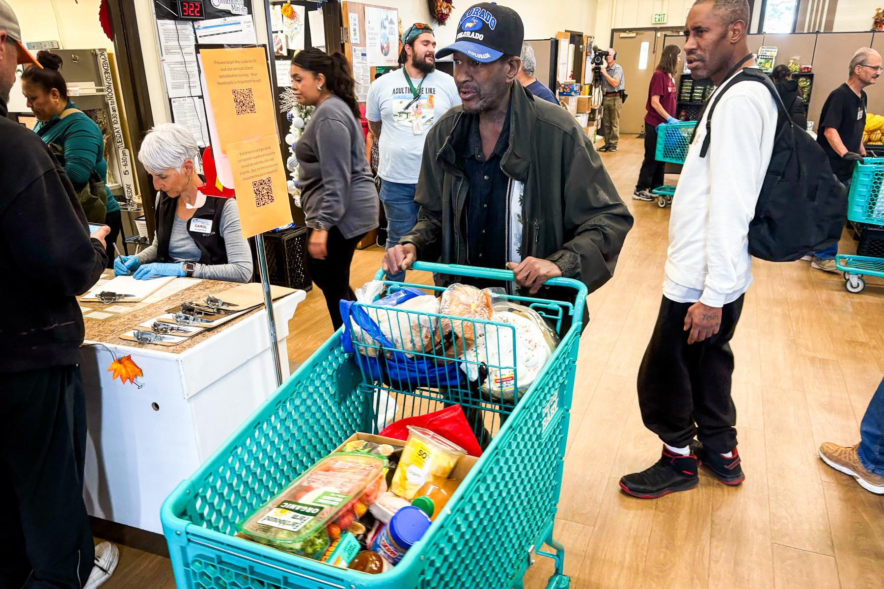 People push shopping carts with food