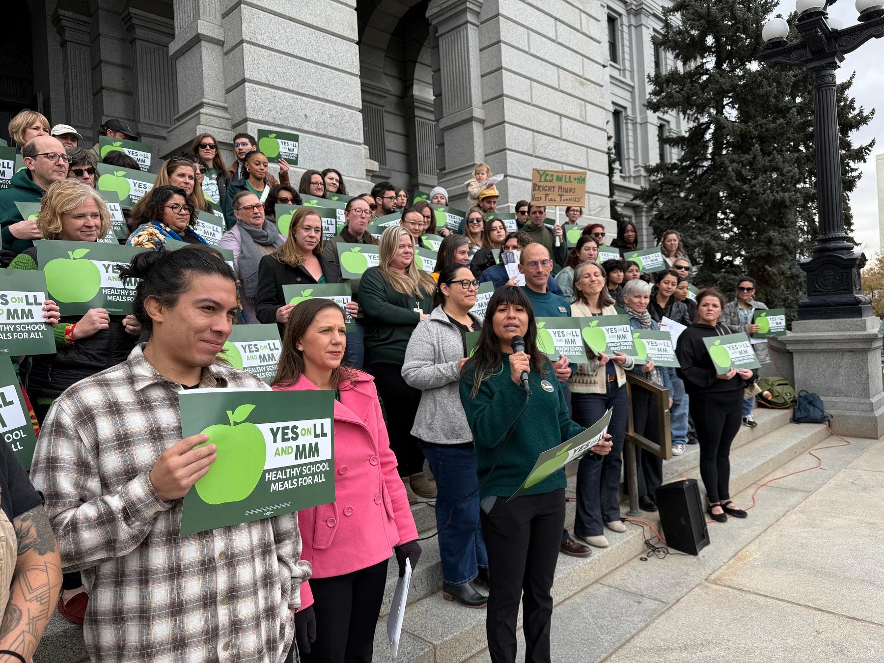 People stand on steps for a rally.