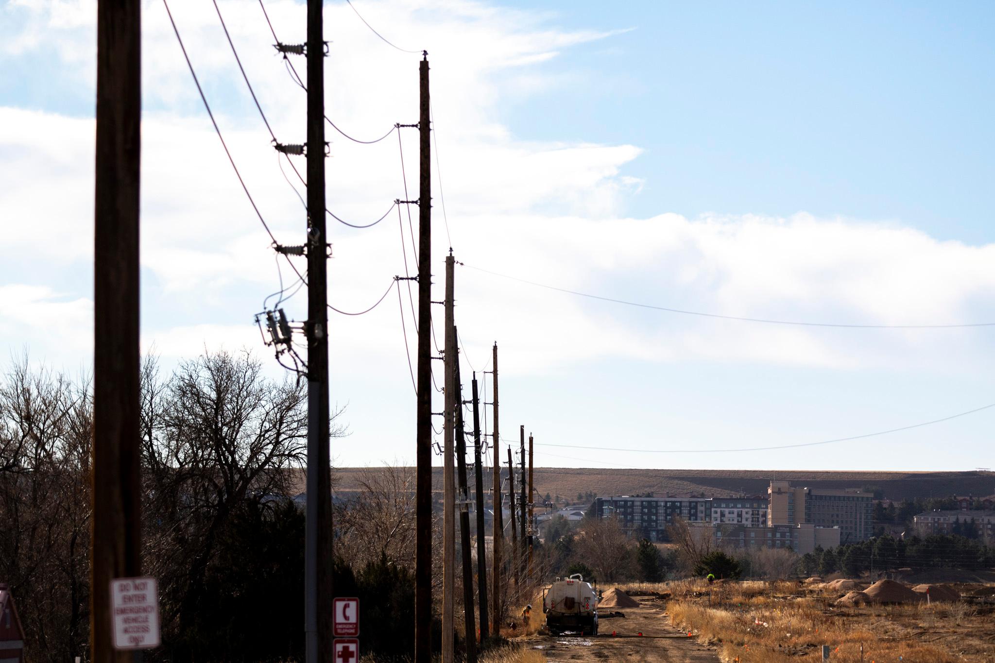 Utility lines stretch across Louisville on a windy day. Dec. 17, 2025.