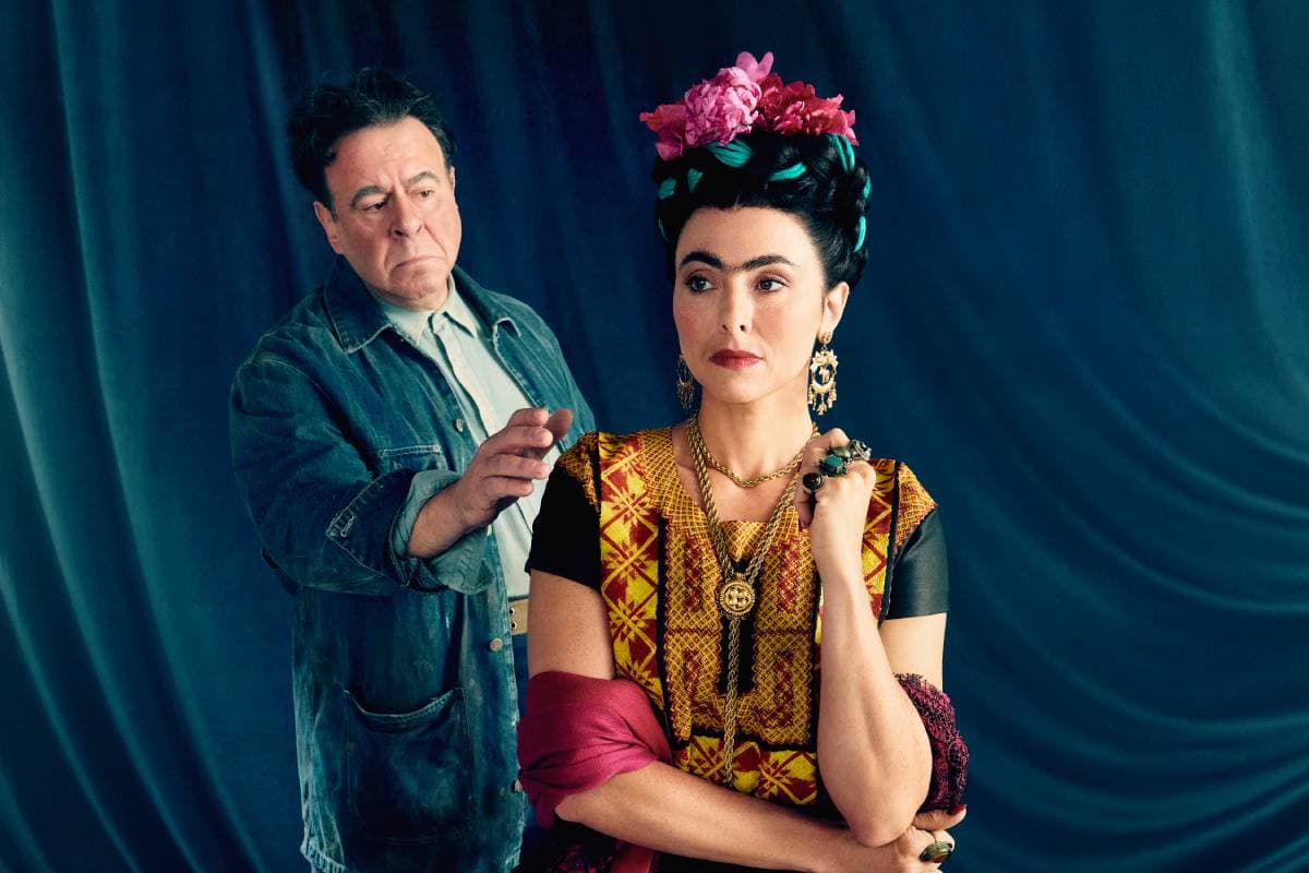 Woman looking to the side with man approaching her from behind.