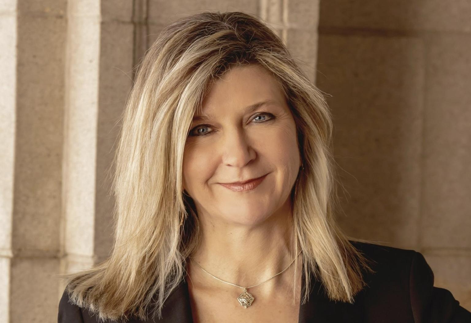 a head and shoulders photo of a smiling woman