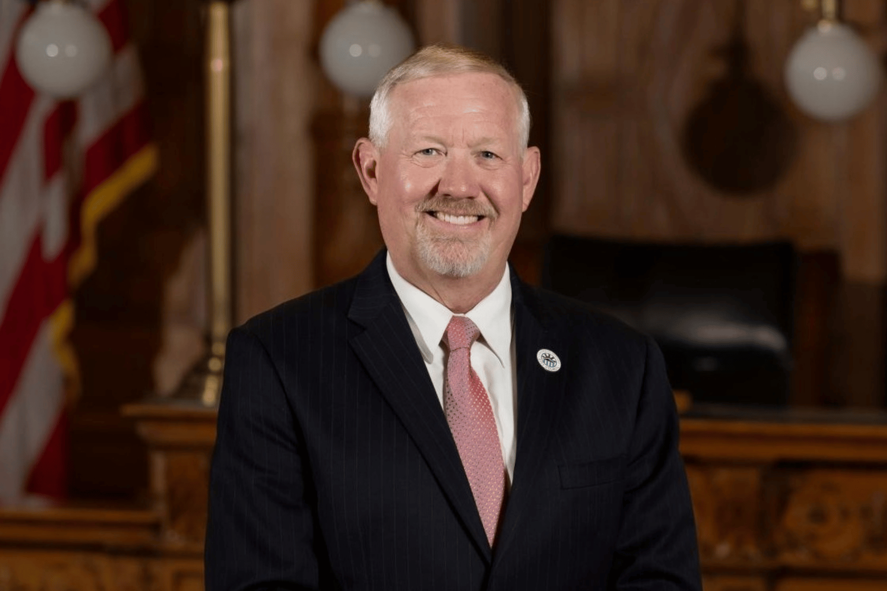 Man in a suit smiling at the camera
