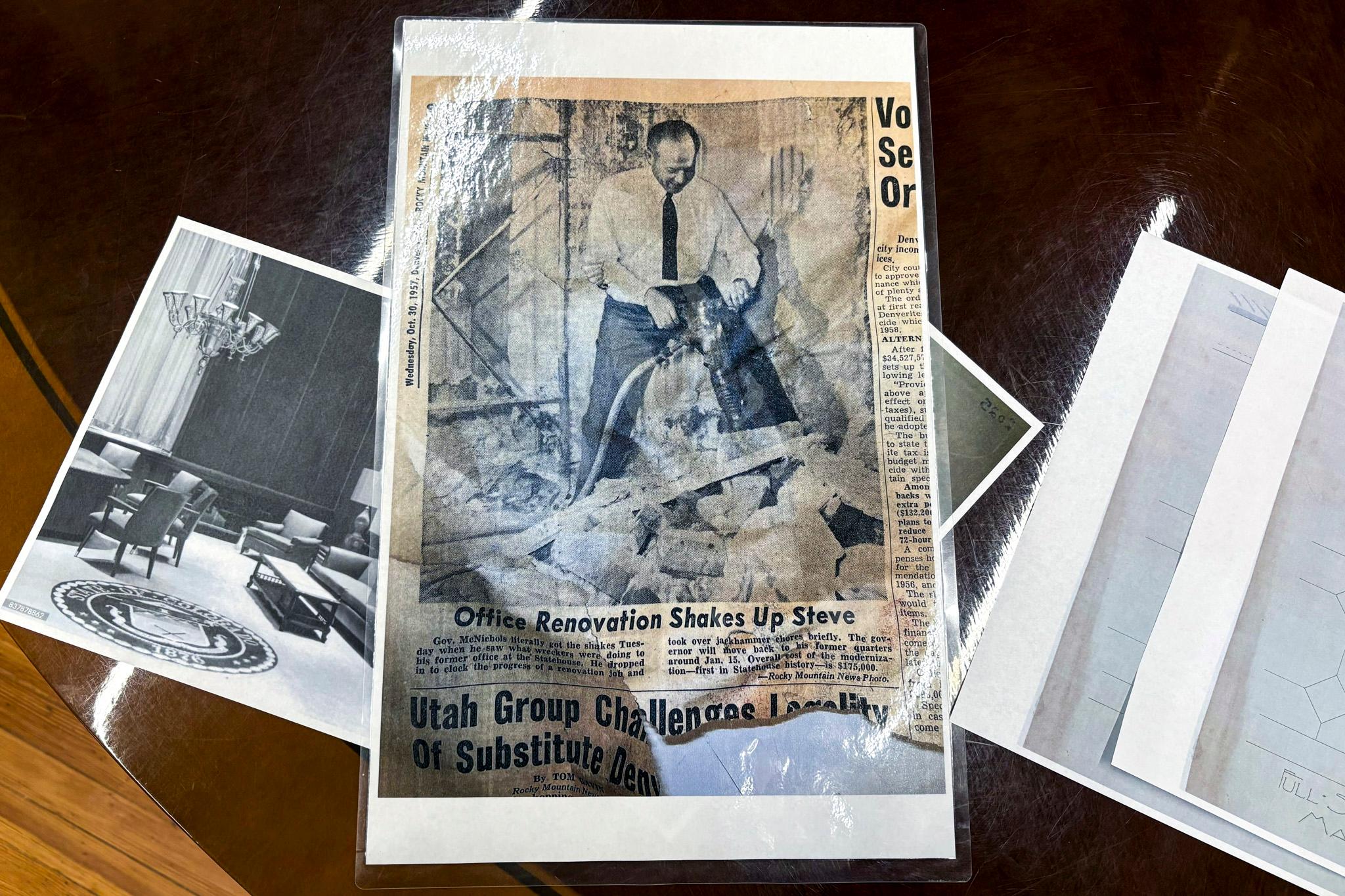 A look down at a laminated printout of an old newspaper article headlined "office renovation shakes up Steve."