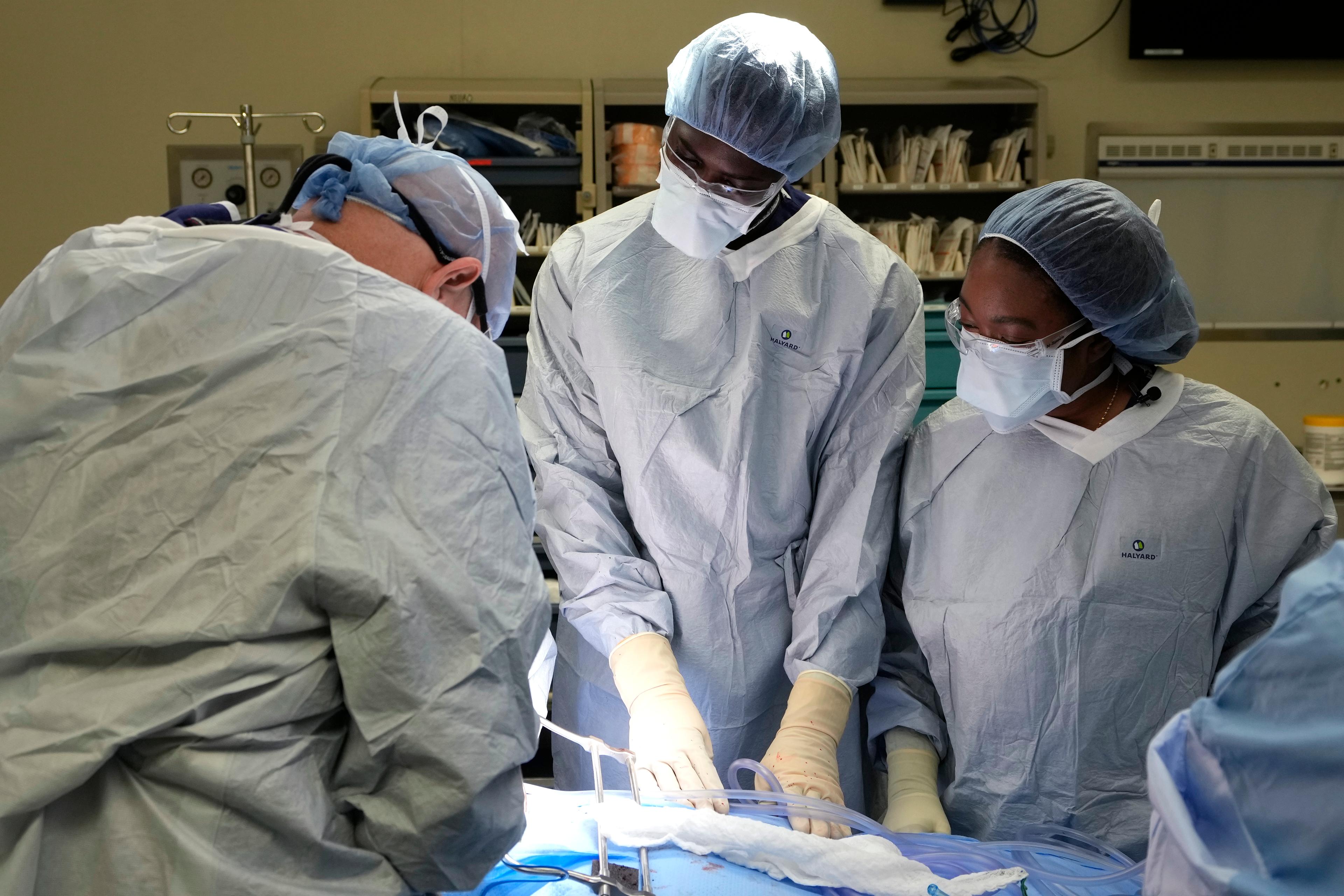Three medical professionals working a hospital.