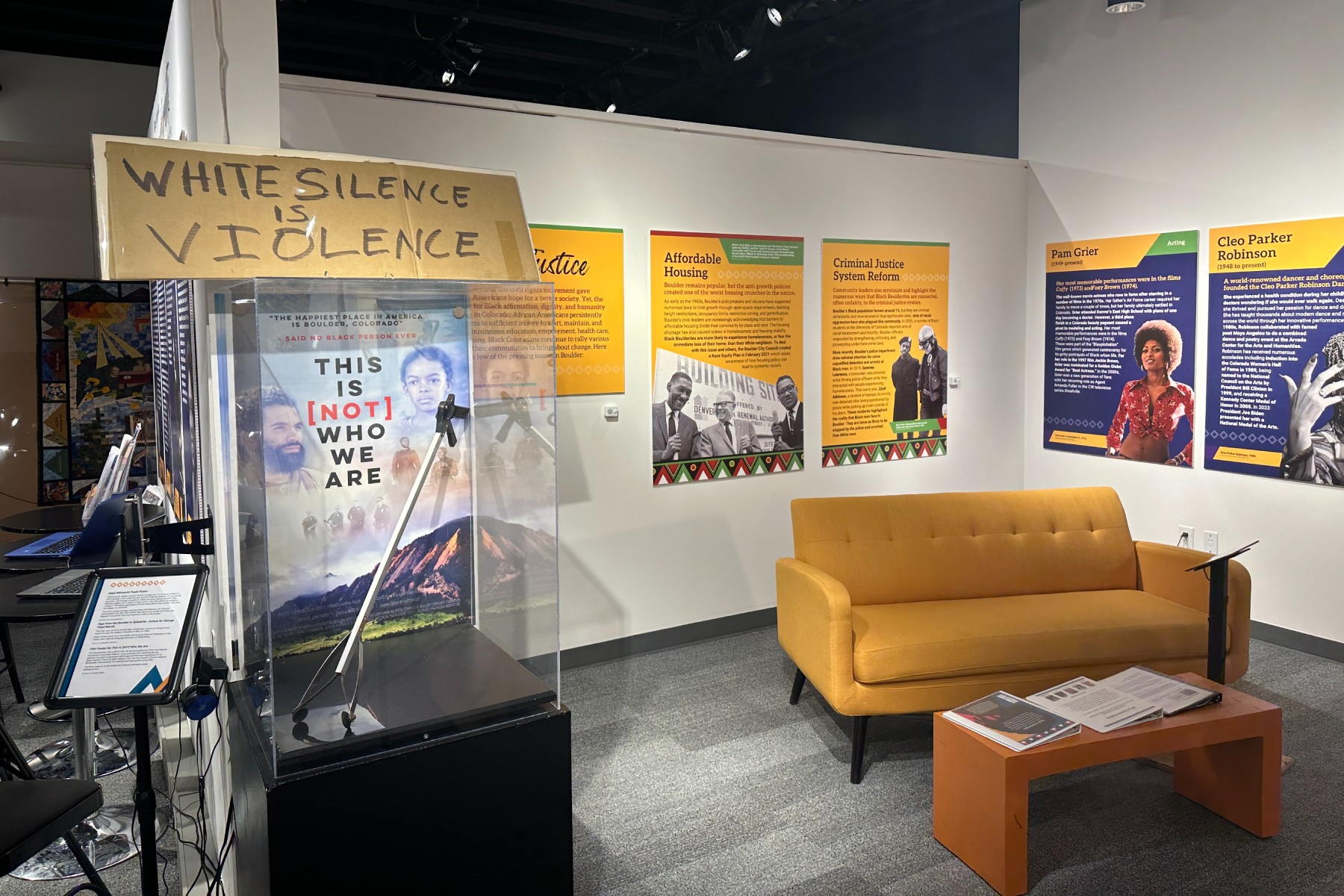 couch surrounded by signage in an art exhibit