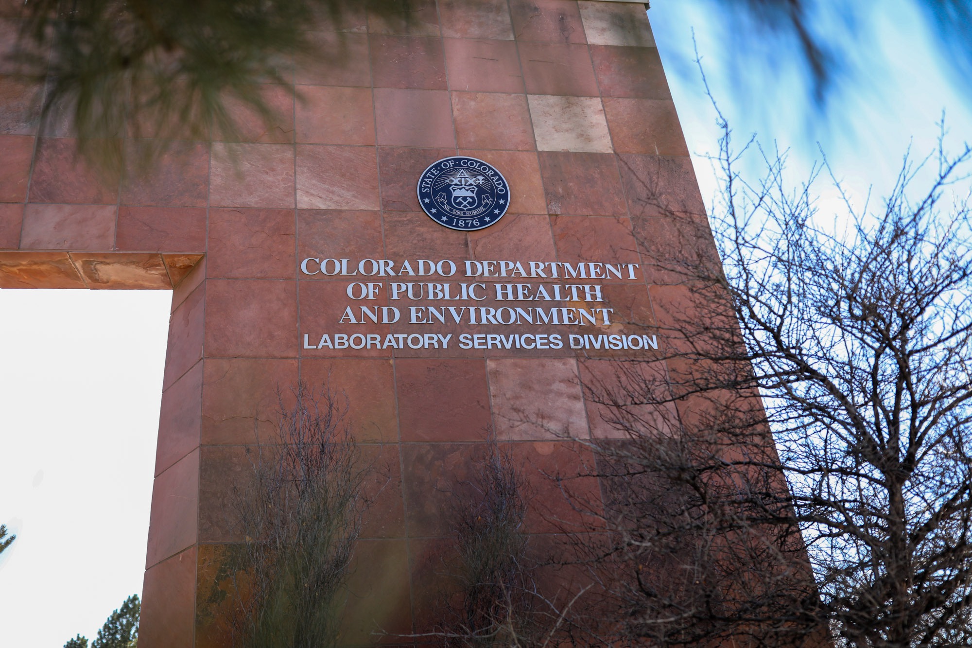 brick building with trees surrounding the border of the picture