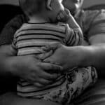 Olathe resident Mars Moreno holds her young son, James Kimball, inside their home west of Olathe, Colo. April 7, 2026.