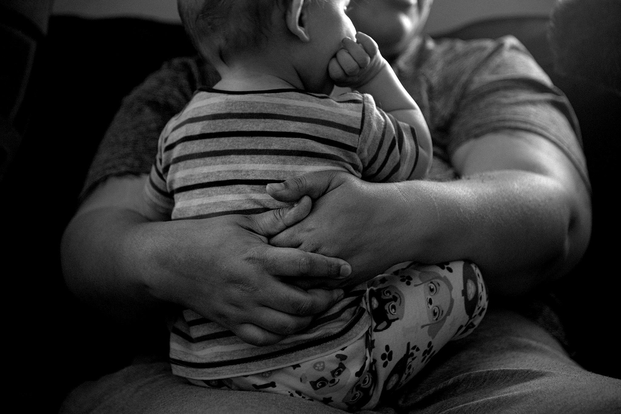 Olathe resident Mars Moreno holds her young son, James Kimball, inside their home west of Olathe, Colo. April 7, 2026.