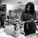 Falon Thomas works in a respiratory therapy lab at school in Aurora on May 13, 2026.