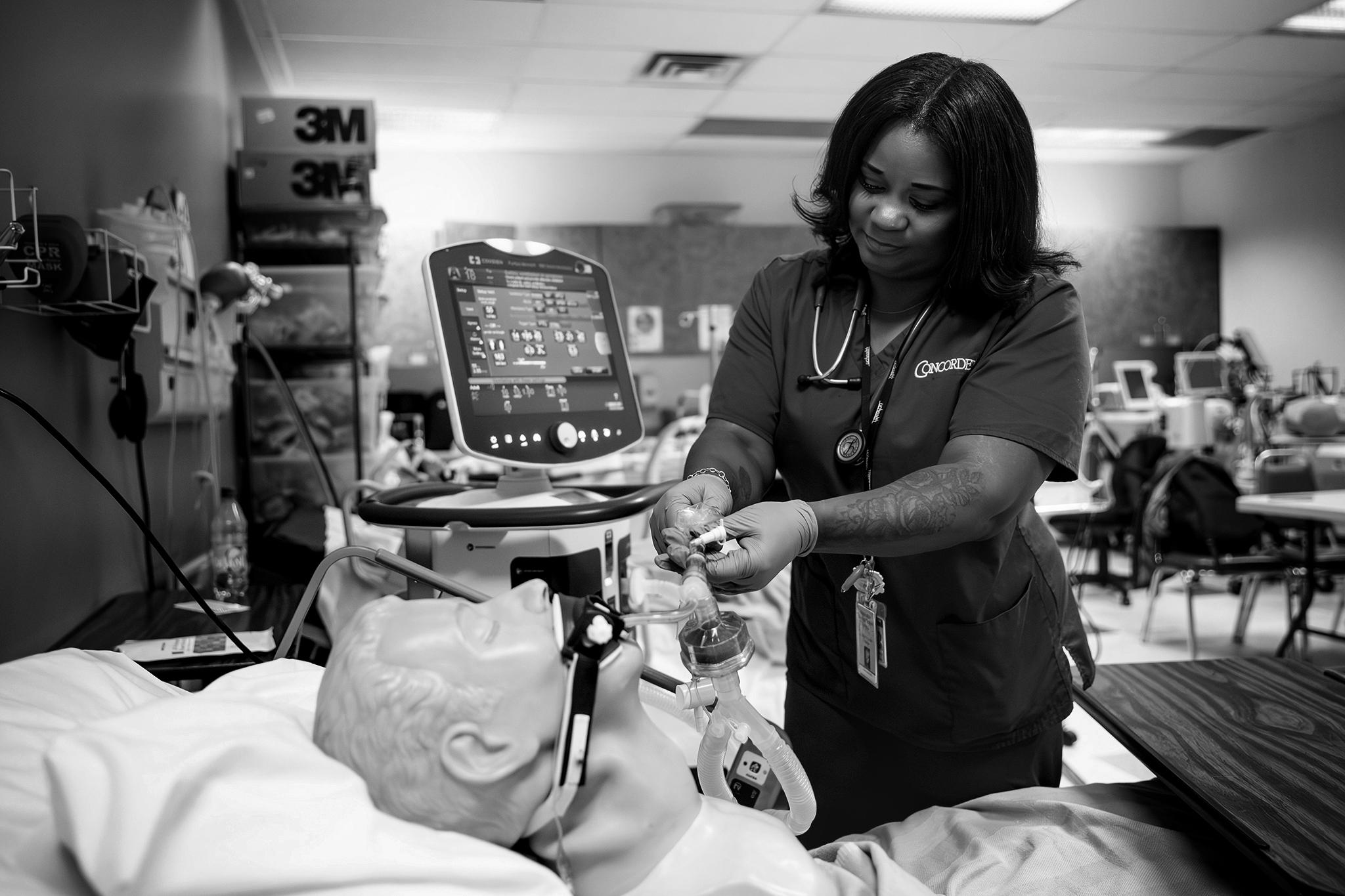 Falon Thomas works in a respiratory therapy lab at school in Aurora on May 13, 2026.